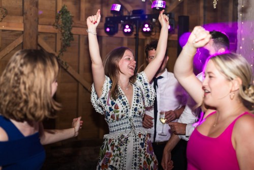 A wedding guest dancing at Over Barn