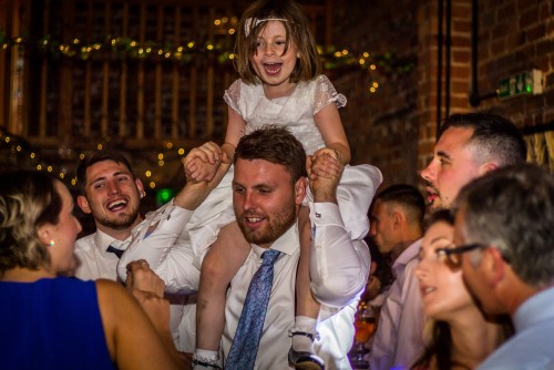 Little girl lifted onto shoulder at Curradine Barns