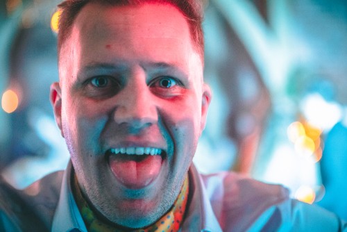 Guest sticking his tongue out to the Wedding Disco at Shustoke Farm Barns in Warwickshire