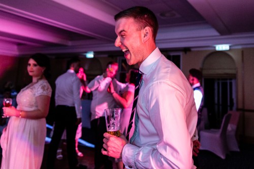Happy man dancing to the wedding disco at Ardencote Manor in Warwick